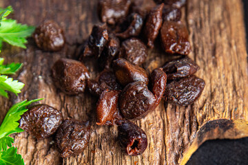 olives black pitted dried fruit smoked food snack on the table copy space food background 