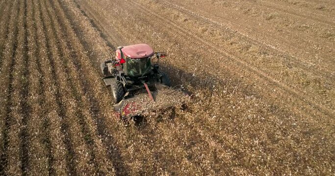 Kibbutz, Israel - 25 November 2021: Aerial view of a tractor shredding a cotton field leftover, Kibbutz Saar, Mate Asher, Israel