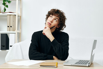 guy on a white sofa in front of a laptop learning Lifestyle technology