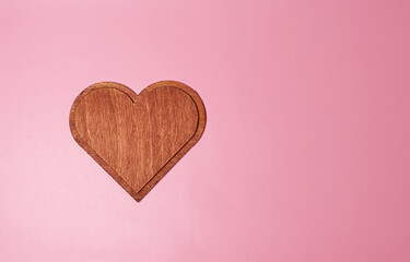 A large wooden heart of dark brown color