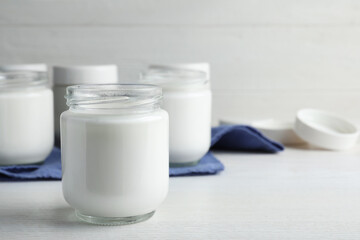 Obraz na płótnie Canvas Tasty yogurt on white wooden table. Space for text