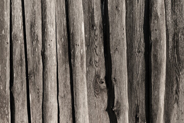 Old grungy dark wooden wall. Front view, background