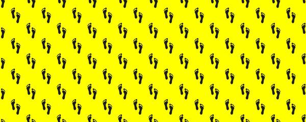 the trace of a man on a yellow background. black trail. seamless drawing of images of a human footprint on a yellow background. top view on the trail. Banner for insertion into site