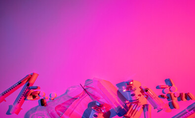 Antiviral medication. Covid-19 banner. Pharmaceutical lab research. Neon light vaccine bottle dose syringe pills test tube on bright pink purple color gradient copy space background.