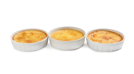 Delicious creme brulee in ceramic ramekins on white background
