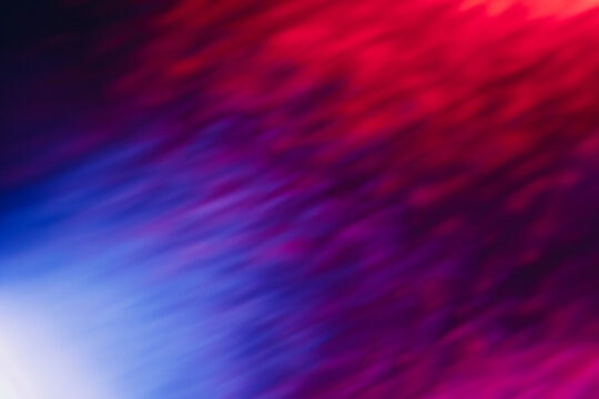 Defocused glow overlay. Neon radiance. Disco illumination. Blur led blue purple pink red white color light rays on dark black abstract background.