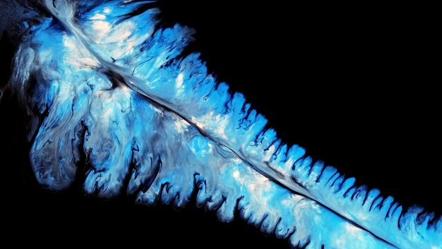 blue liquid paints isolated on black background