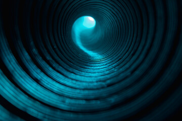 Neon tunnel. Blur glow background. Round geometric pattern. Fluorescent glare. Defocused cyan blue color light on grooved circles texture dark black abstract overlay.