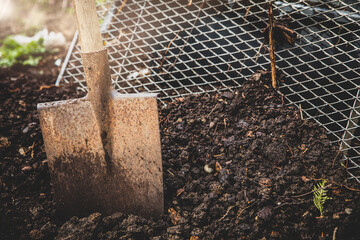 Shovel with compost soil and sieve - obrazy, fototapety, plakaty
