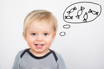 Thinking  and smiling cute little caucasian child isolated on white background with bubble and candy. Healthy teeth concept.