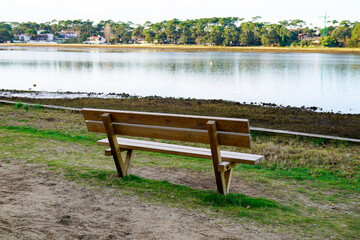 Fototapeta premium wooden bench canal beach on Hossegor lake in Landes France