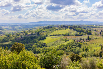 Fototapeta na wymiar View of a valley with rolling hills in Tuscany in Italy