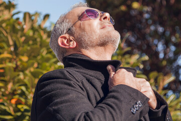 relaxed man in autumn breathing outdoors