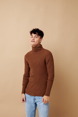 A young man stylish hairstyle brown turtleneck isolated background unaltered
