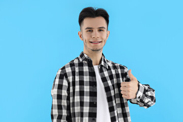 Attractive guy in shirt on blue background