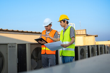 Male industrial engineers and architects consult and brainstorm ideas to modify the installation...