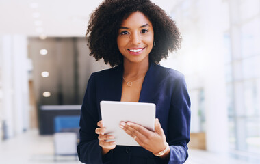 Updating my work schedule. Cropped portrait of an attractive young businesswoman standing alone and...