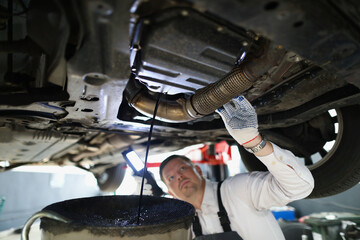 Man repairman fixing car in workshop closeup