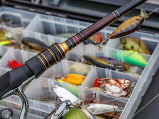 A large fisherman's tackle box fully stocked with lures and gear for fishing.fishing lures and...