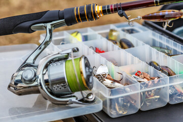 A large fisherman's tackle box fully stocked with lures and gear for fishing.fishing lures and...