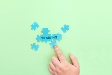 Businessman connecting puzzle pieces with the word Training