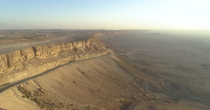 Aerial view of a winding road on a mountain side in the desert at sunrise, Paran rive, Negev, Israel.
