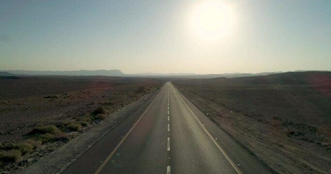 Aerial view of an endless road crossing the desert, Mizpe Ramon, Negev, Israel.