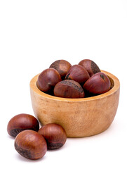 Group of roasted chestnuts on a wooden bowl isolated on a white background.