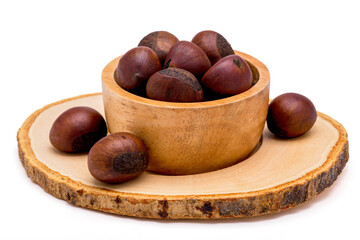 Group of roasted chestnuts on a wooden bowl isolated on a white background.