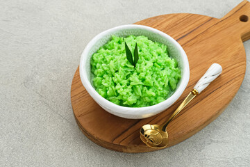 Tape Ketan Pandan is a typical Indonesian food made from fermented sticky rice. Served in small bowl. Selected focus.
