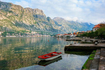 Landscape with boat, houses and mountains in Kotor Bay, Montenegro