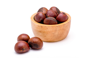 Group of roasted chestnuts on a wooden bowl and in front off bowl isolated on a white background.