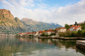 Landscape with houses with tiled roofs and mountains in Kotor Bay, Montenegro