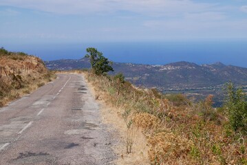 Scenic road overlooking the Mediterranean Sea winding through Balagne. Corsica, France.