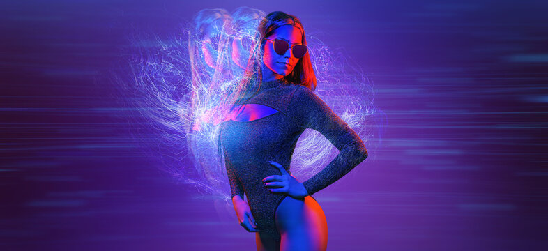 Fashionable glamour beautiful woman with Trendy wavy neon light hairstyle. Party night club vibes, gel filter. Excited shapely sexy girl. Bright pink blue lighting. Art fashion creative neon color.