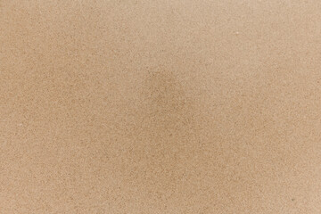 Sand background. Natural smooth sand texture. Sandy beach surface, top view.