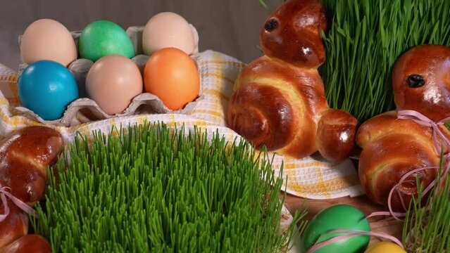 Close-up of festive Easter treats, Easter bunnies, Easter eggs, microgreen sprouts, camera slowly moving across the table