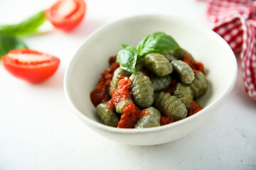 Homemade spinach gnocchi with tomato sauce