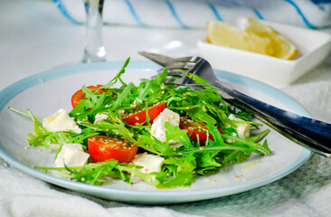 Arugula salad with feta cheese and cherry tomatoes