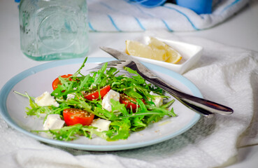 Arugula salad with feta cheese and cherry tomatoes
