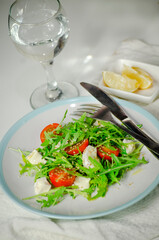 Arugula salad with feta cheese and cherry tomatoes