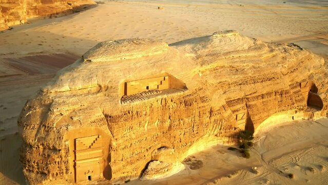 Aerial Panning A Rock Formation With An Ancient Carved Tomb Reflecting Warm Sunlight - Riyadh, Saudi Arabia