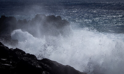 dramatic great wave crushing on the rocks 