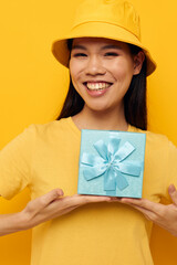 Charming young Asian woman with a gift box in his hands surprise emotions isolated background unaltered