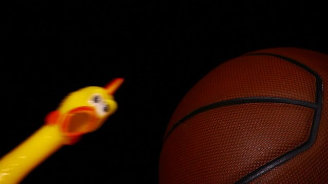 footage of basketball rubber chicken dark background 