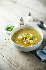Traditional homemade pea soup with smoked bacon