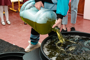 Soap solution for the holiday with soap bubbles close up, soap solution in a vessel for bubbles, a...