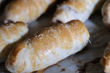 Closeup of delicious appetizing homemade buns on baking sheet