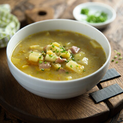 Traditional homemade pea soup with smoked bacon