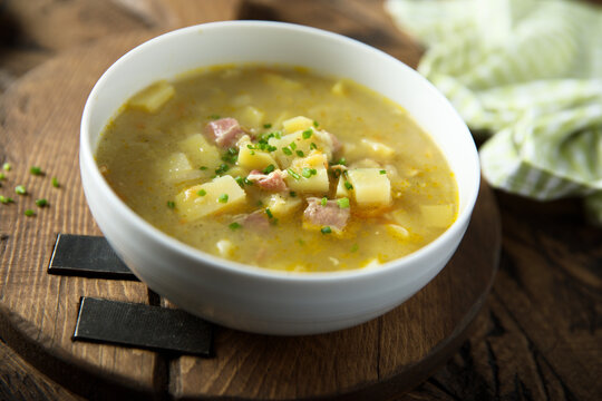 Traditional homemade pea soup with smoked bacon